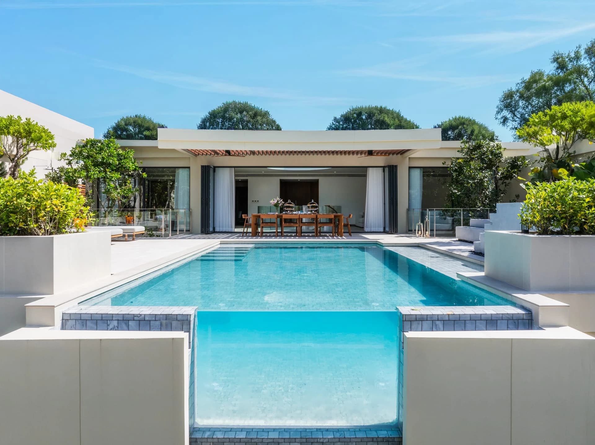 A finished Aegir villa: the symmetrical pool with its glass end and the dining pavilion