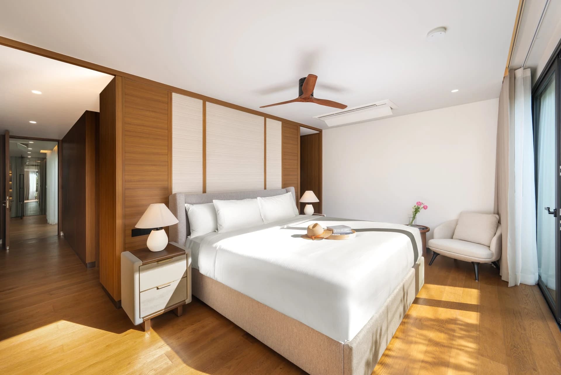A finished Aegir villa: the master bedroom with timber panelling and a ceiling fan